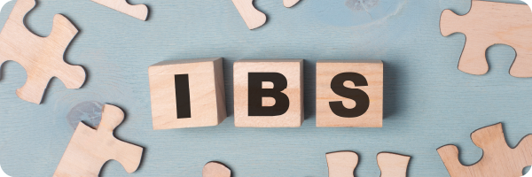 IBS spelled out on individual wooden blocks surrounded by jigsaw pieces