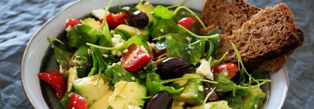 Leafy salad with vegetables and dressing.