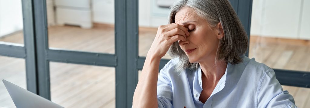 Fatigued woman rubbing her eyes