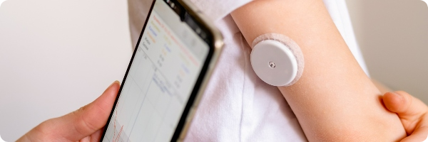 A person with type 1 diabetes wears a patch on their arm to monitor blood sugar.
