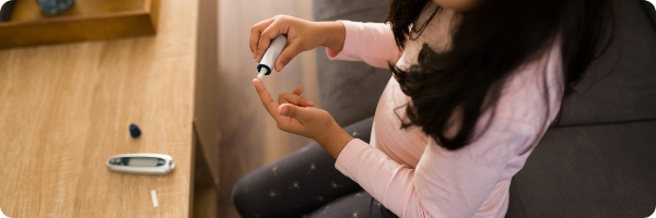 A woman with type 1 diabetes conducts a fingerprick test for blood sugar.