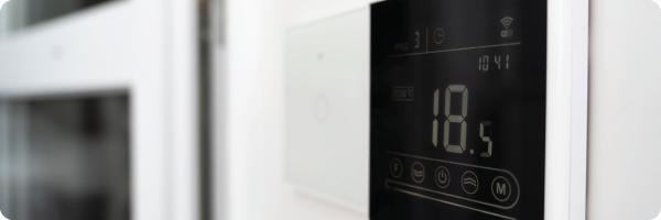 Thermostat in home representing an ideal room temperature indoors.