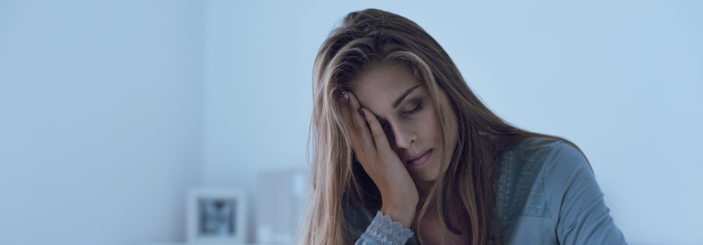 Woman asleep with her head in her hand