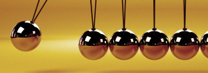 A Newton's cradle on a bright yellow background to represent cause and effect for headache triggers and how to avoid headaches and migraines.