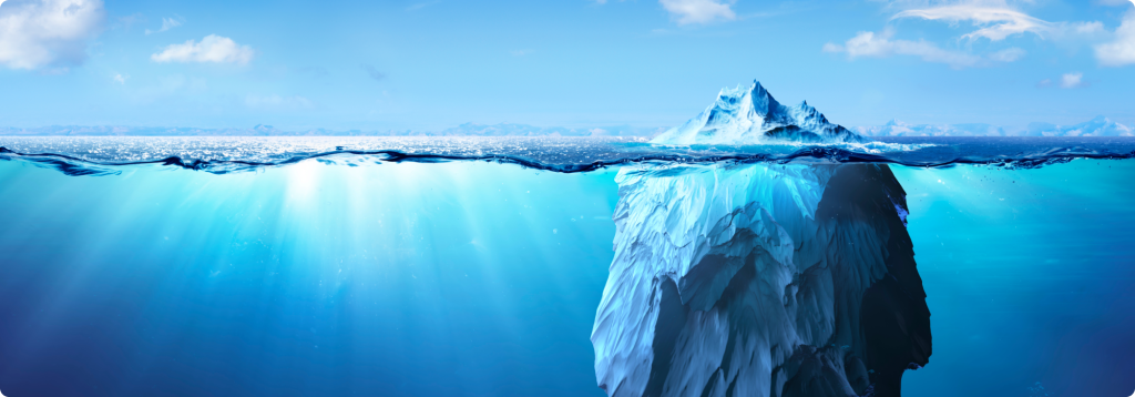 An iceberg shown both above and below the water surface.