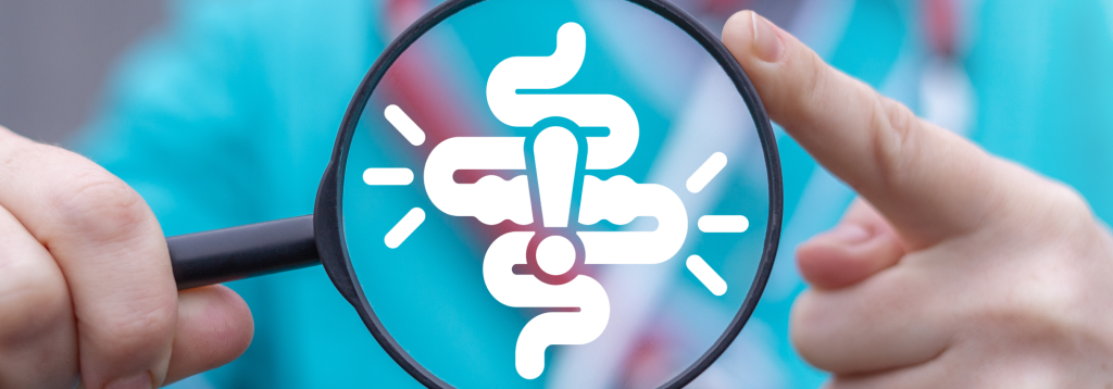 An icon of an intestine in a magnifying glass with an exclamation mark in the centre. A person wearing medical scrubs is holding the magnifying glass.